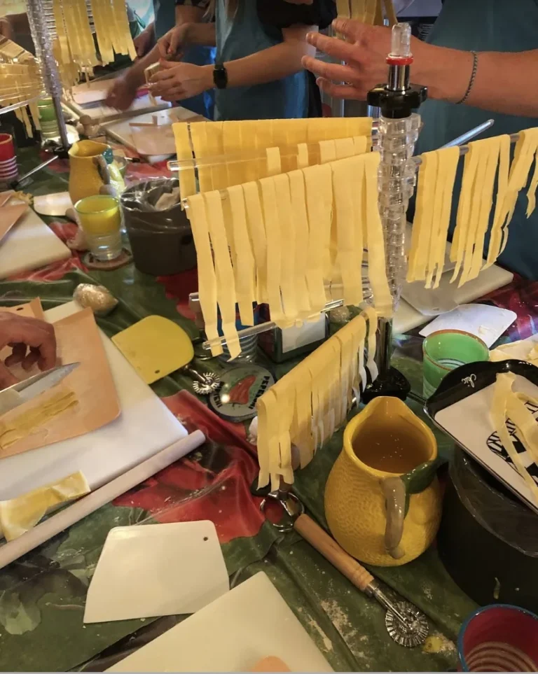 Fresh tagliatelle drying on a pasta rack