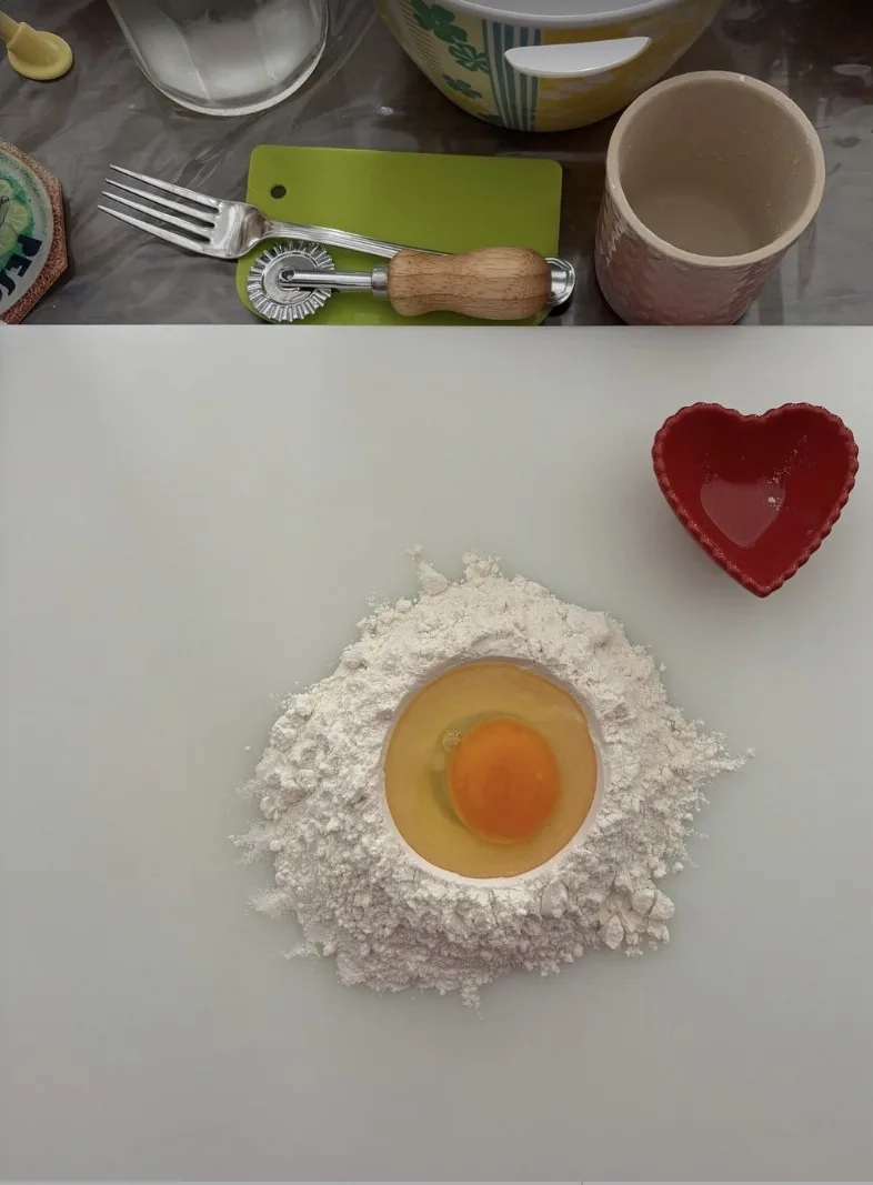 Hands making a heart-shaped egg well for fresh pasta during a family cooking class in Milan