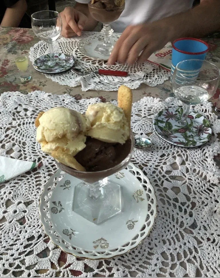 Homemade gelato with ladyfingers on a lace doily