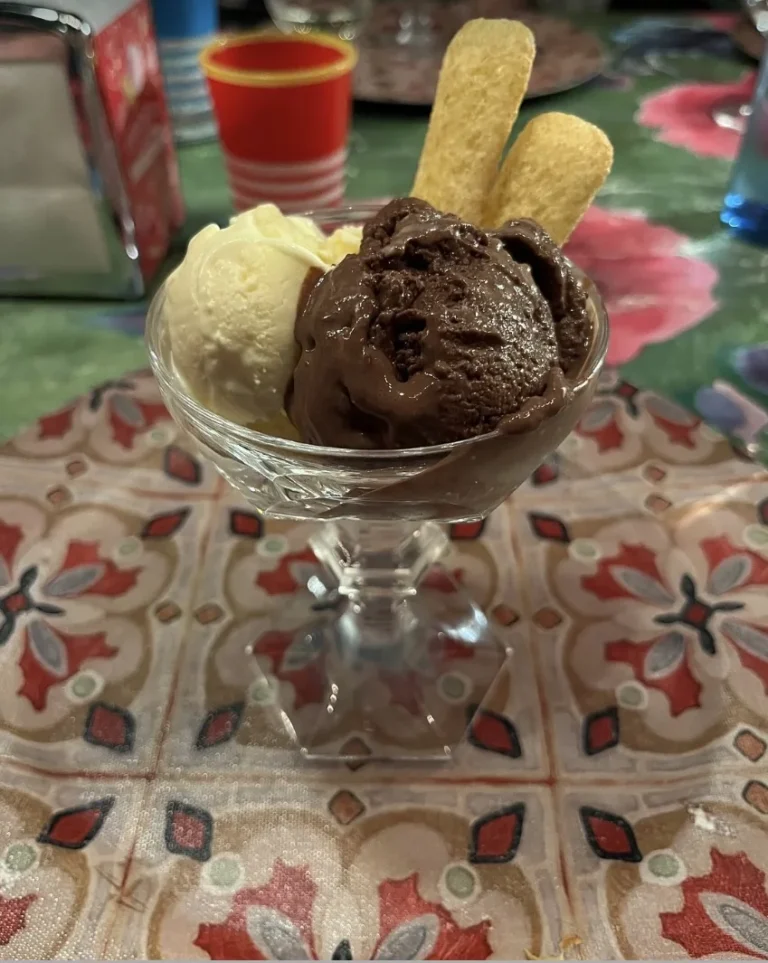 Gelato with ladyfinger biscuits in a glass coupe