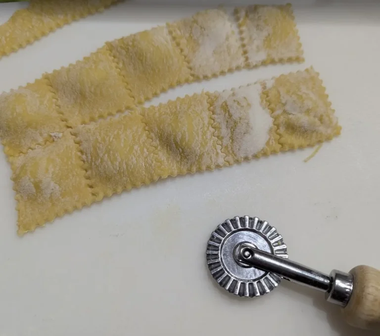 Square ravioli cut with a fluted pasta wheel